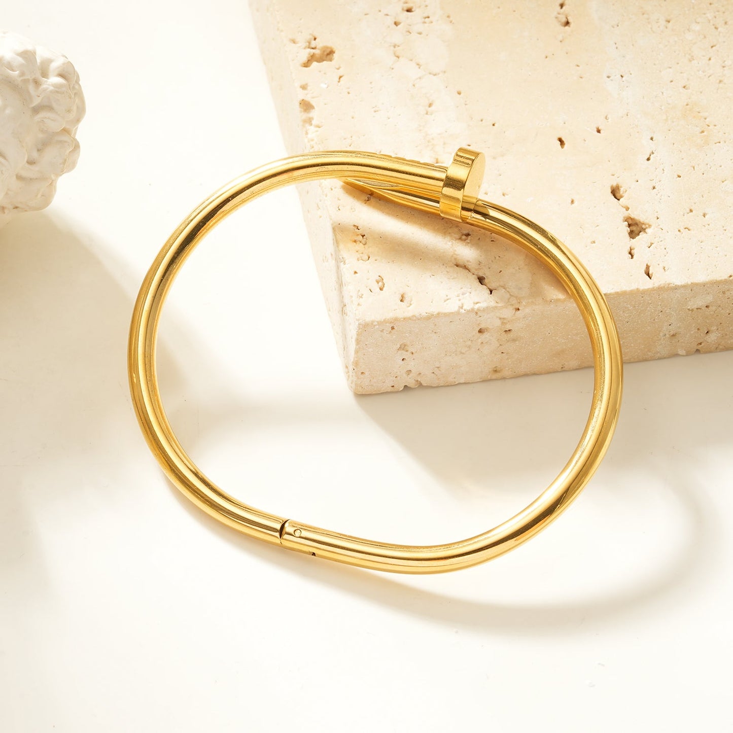 AGOTA Gold: Industrial-Chic Twisted Nail Bracelet