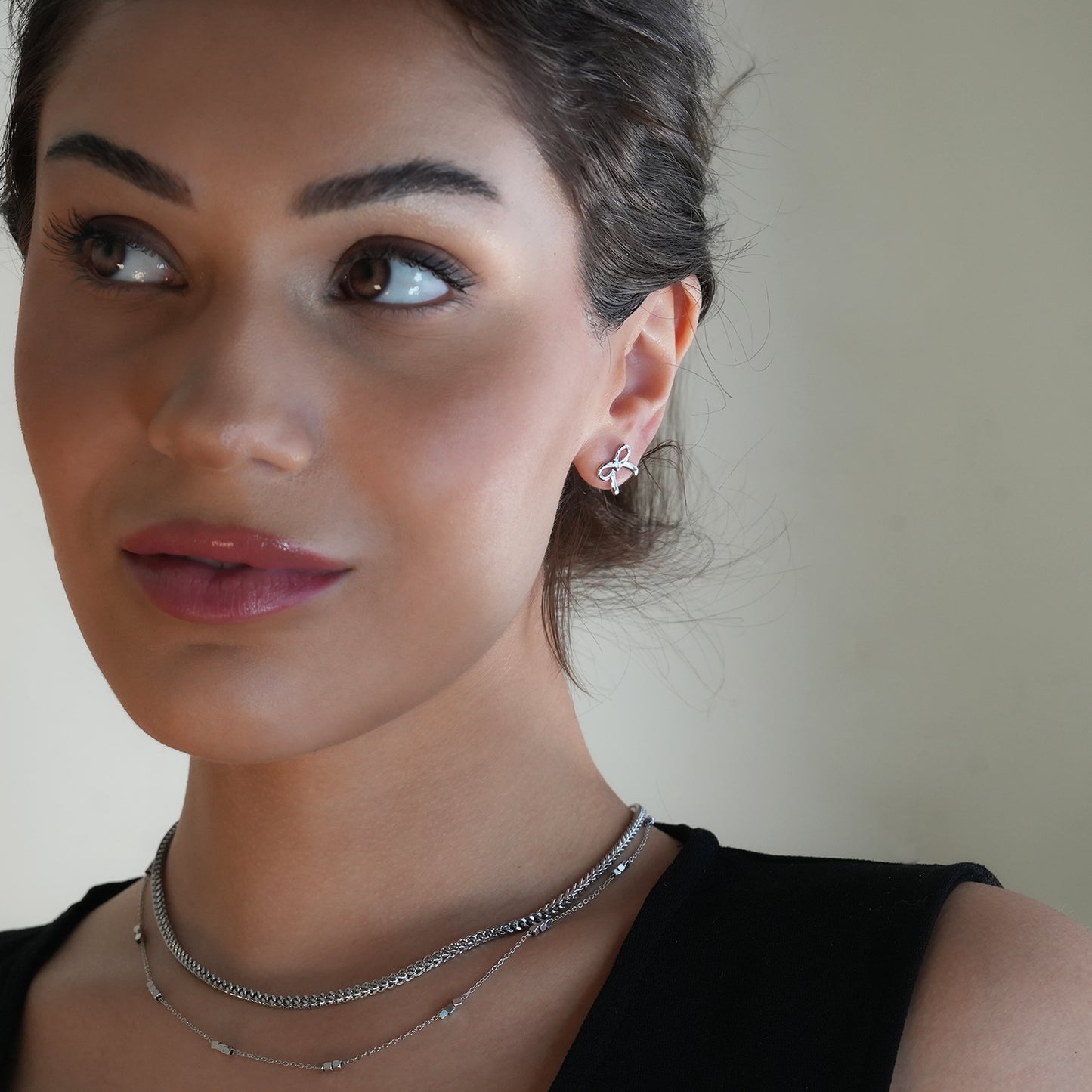 BOW: Silver Toned White Gold Bow Shaped Stud Earrings