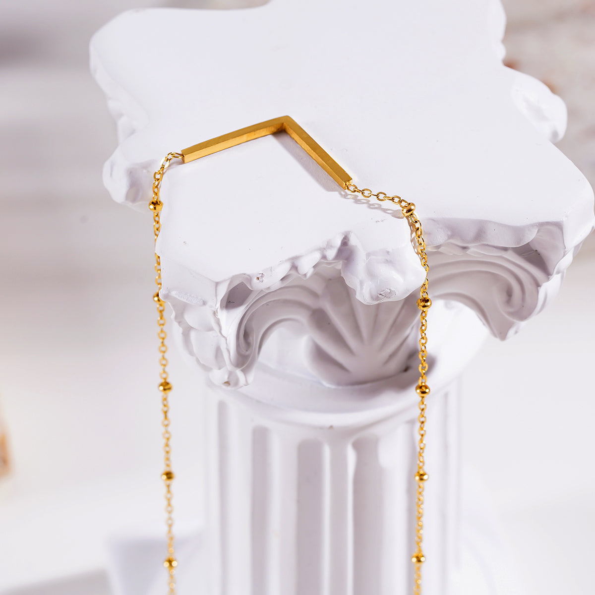 Style SANITA 9712: Beaded Dainty Chain Anchoring 'V' Shaped Zirconia Embedded Pendant Charm.
