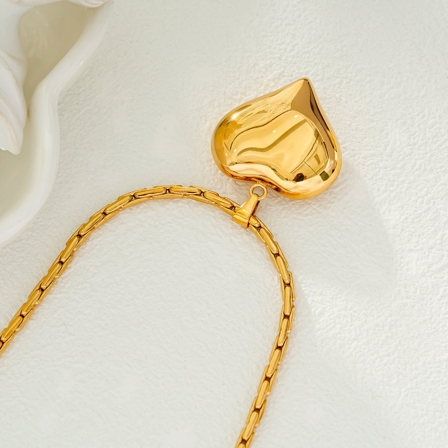 ABEL: Engineered Cable Chain with Puffy Heart Pendant in Gold.