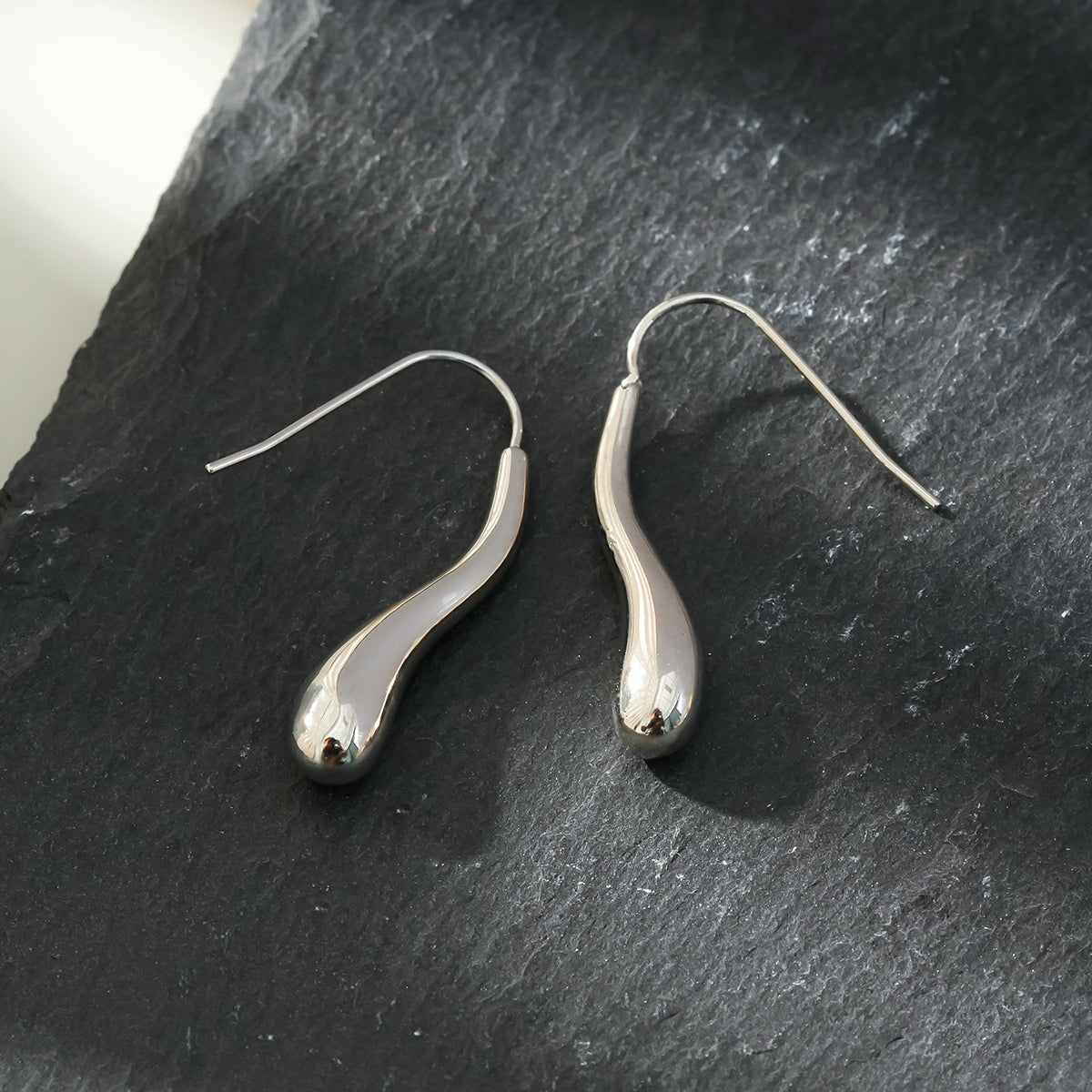 Style CORNING Silver Toned (White Gold): Tadpole-Shaped Earrings – Unique Elegance with a Playful Twist