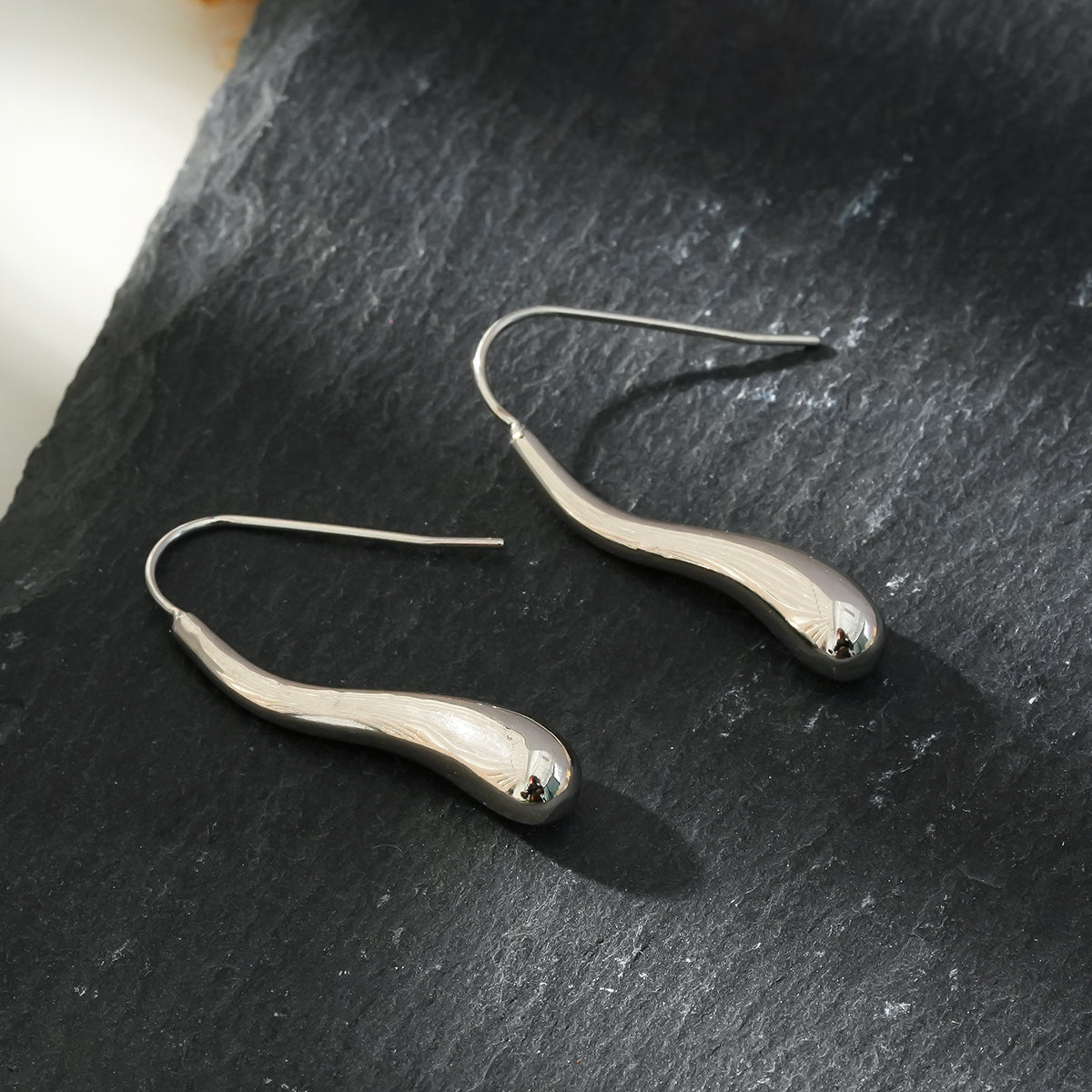 Style CORNING Silver Toned (White Gold): Tadpole-Shaped Earrings – Unique Elegance with a Playful Twist