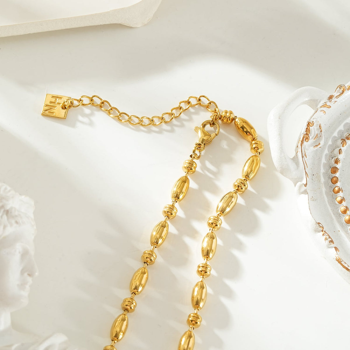 NEEMA Gold: Polished Oval Bead Necklace – Sculpted Statement Jewellery $35