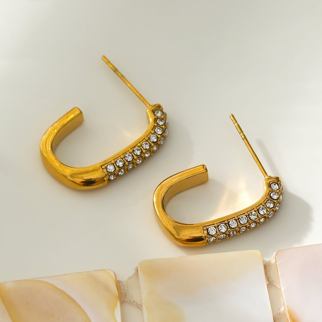 Style FIRLE: Partial Pavé Zirconia Oval Hoop Earrings