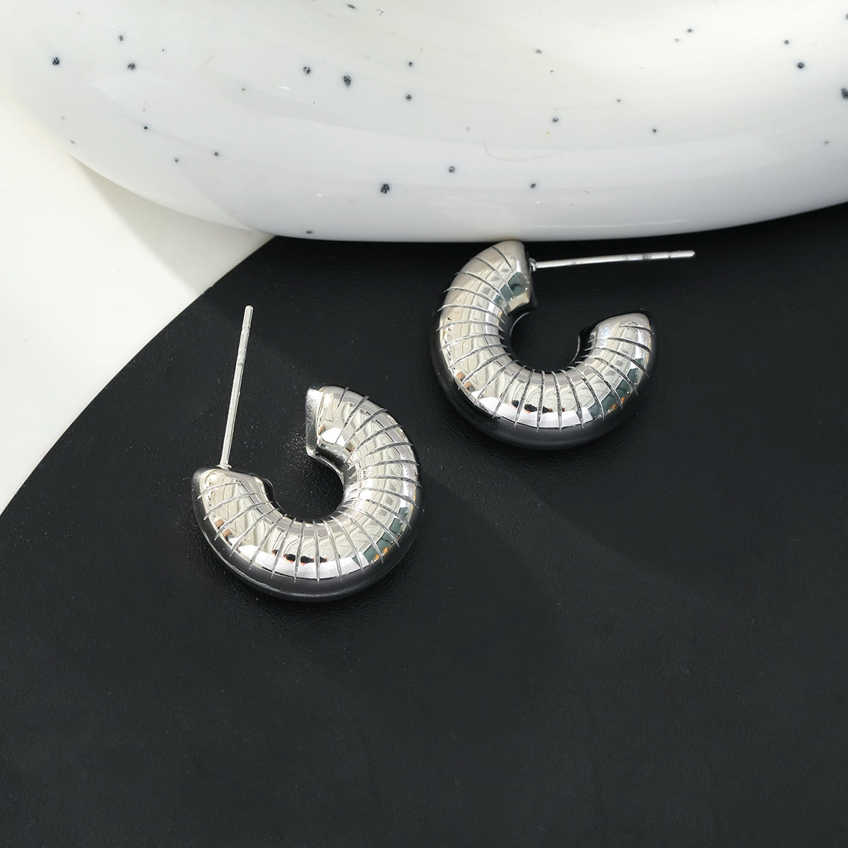 KOTOHIRA: Hollow Chunky-Look Textured Surface Tube Hoop Earrings in Silver Toned White Gold