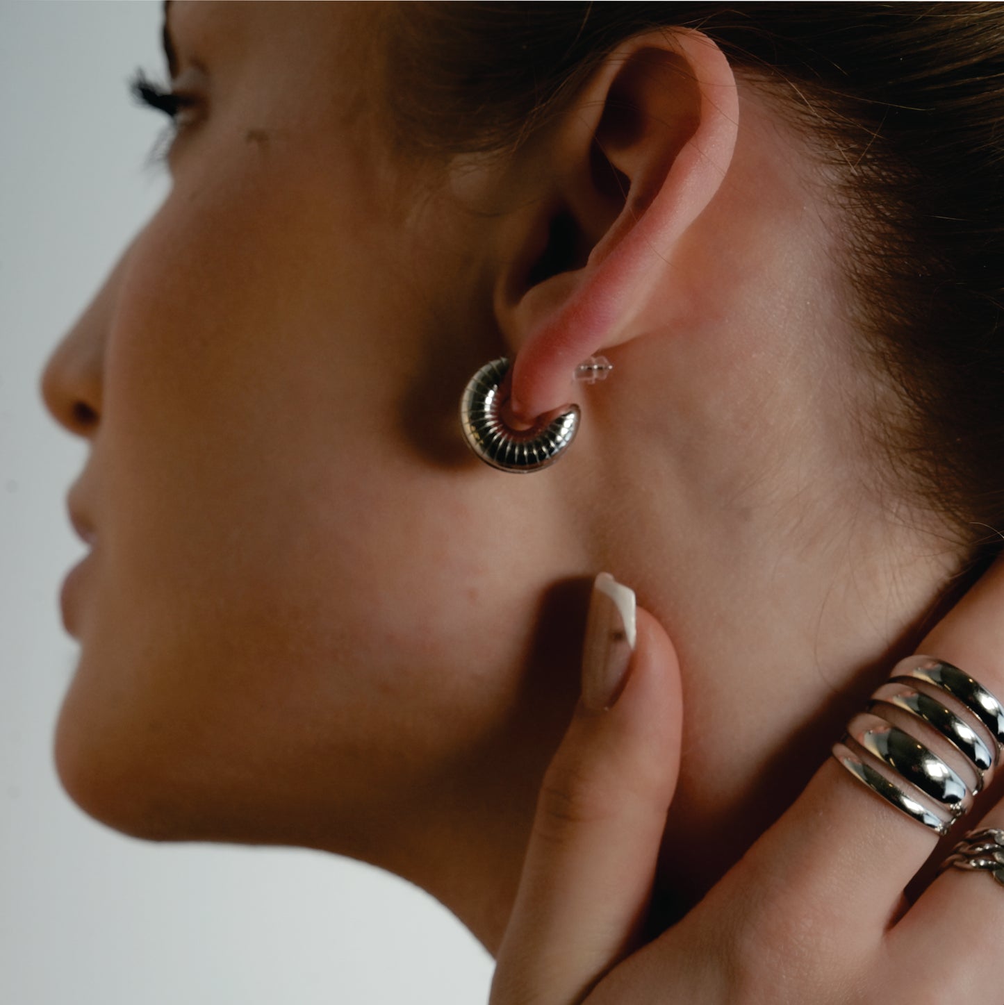 KOTOHIRA: Hollow Chunky-Look Textured Surface Tube Hoop Earrings in Silver Toned White Gold