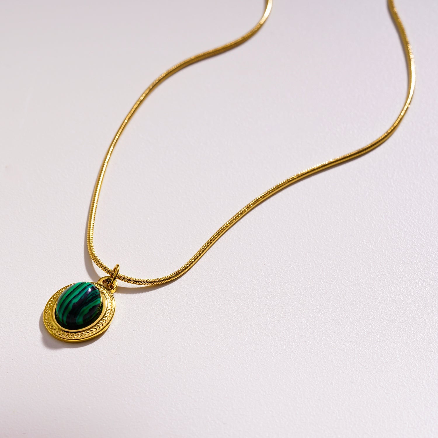 KRISTOS: Vintage Inspired Snake Skin Chain anchoring a Malachite Oval Pendant