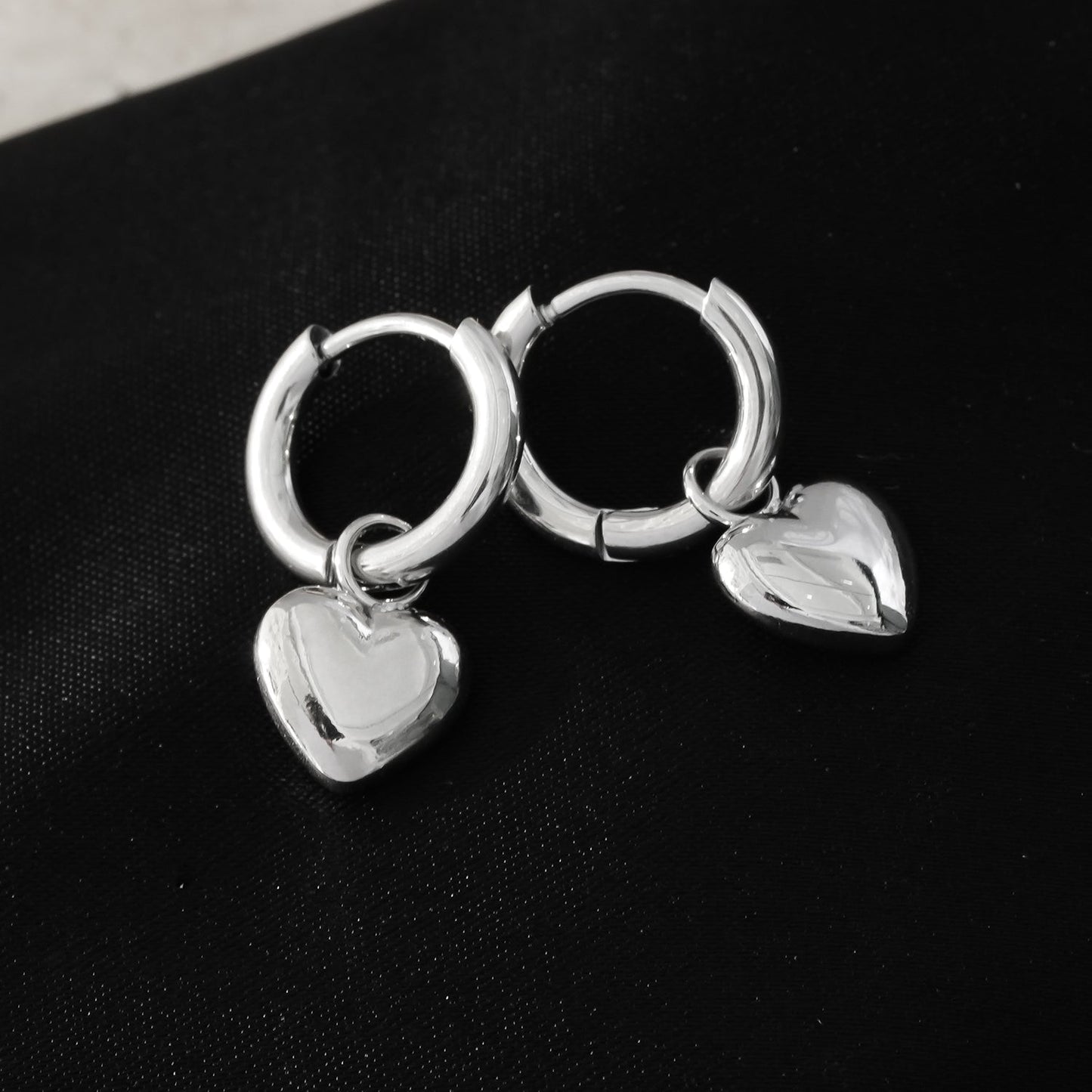 Mini Hoop Earrings Anchoring a Heart Shaped Charm - Style STOWE in Silver Toned White Gold