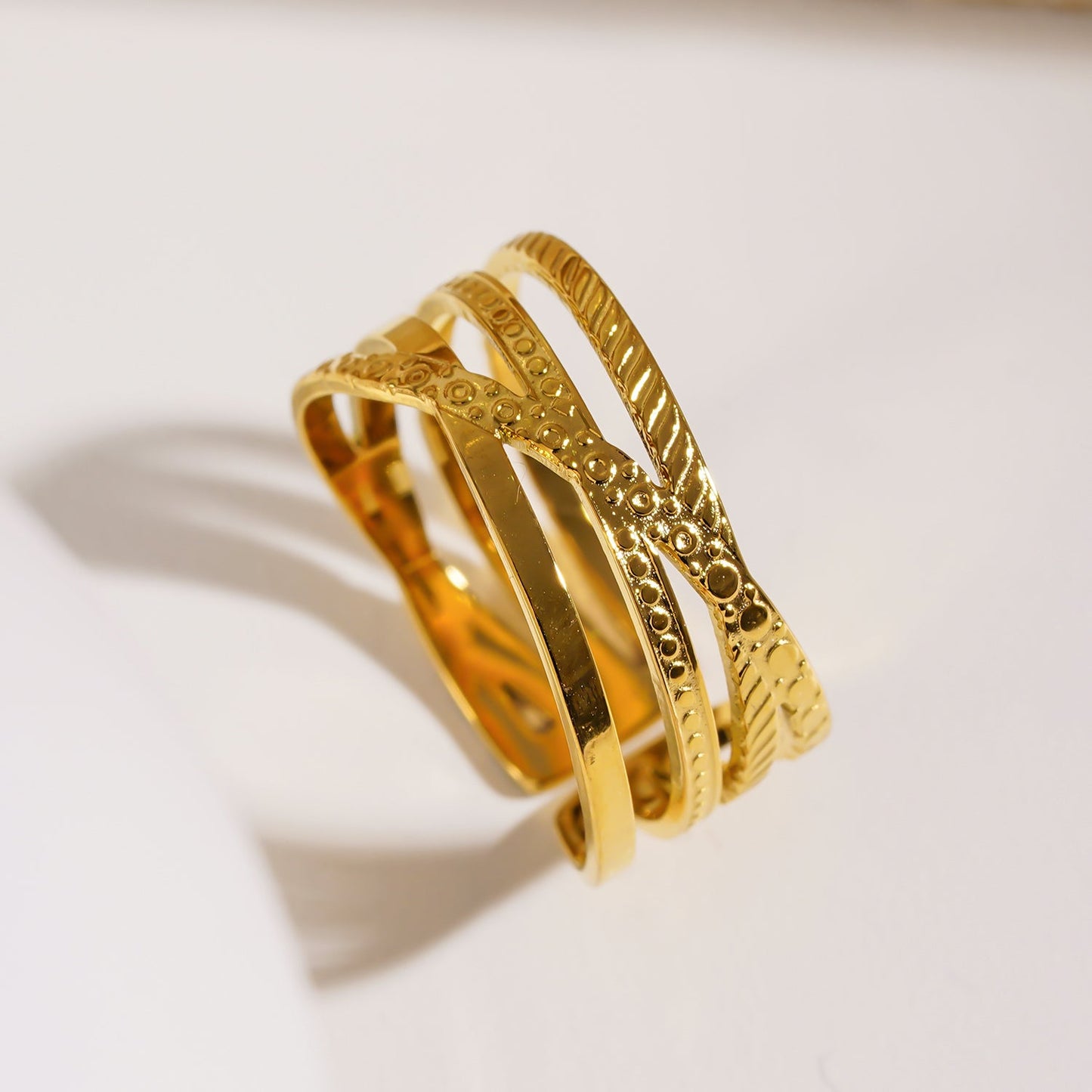 Style ALOIS 7793: Cross Over Multi Stacked Textured Gold Ring.