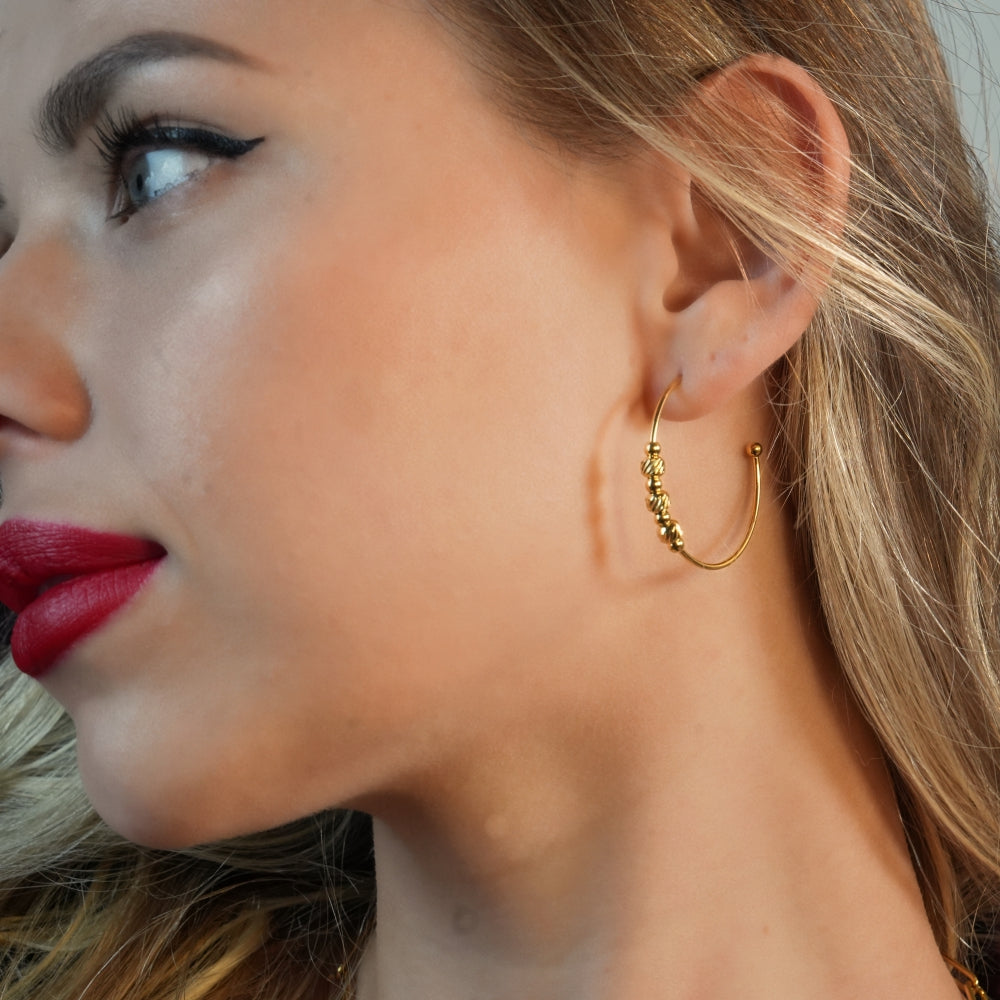 CHARIS: Classic Round Hoop Earrings Anchoring a Bevy of Charm Beads